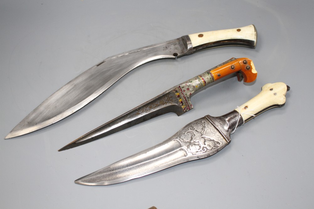 An Indian kukri c.1900, blade 31cms integral with hilt, layered ivory and horn grips, nickel pommel,